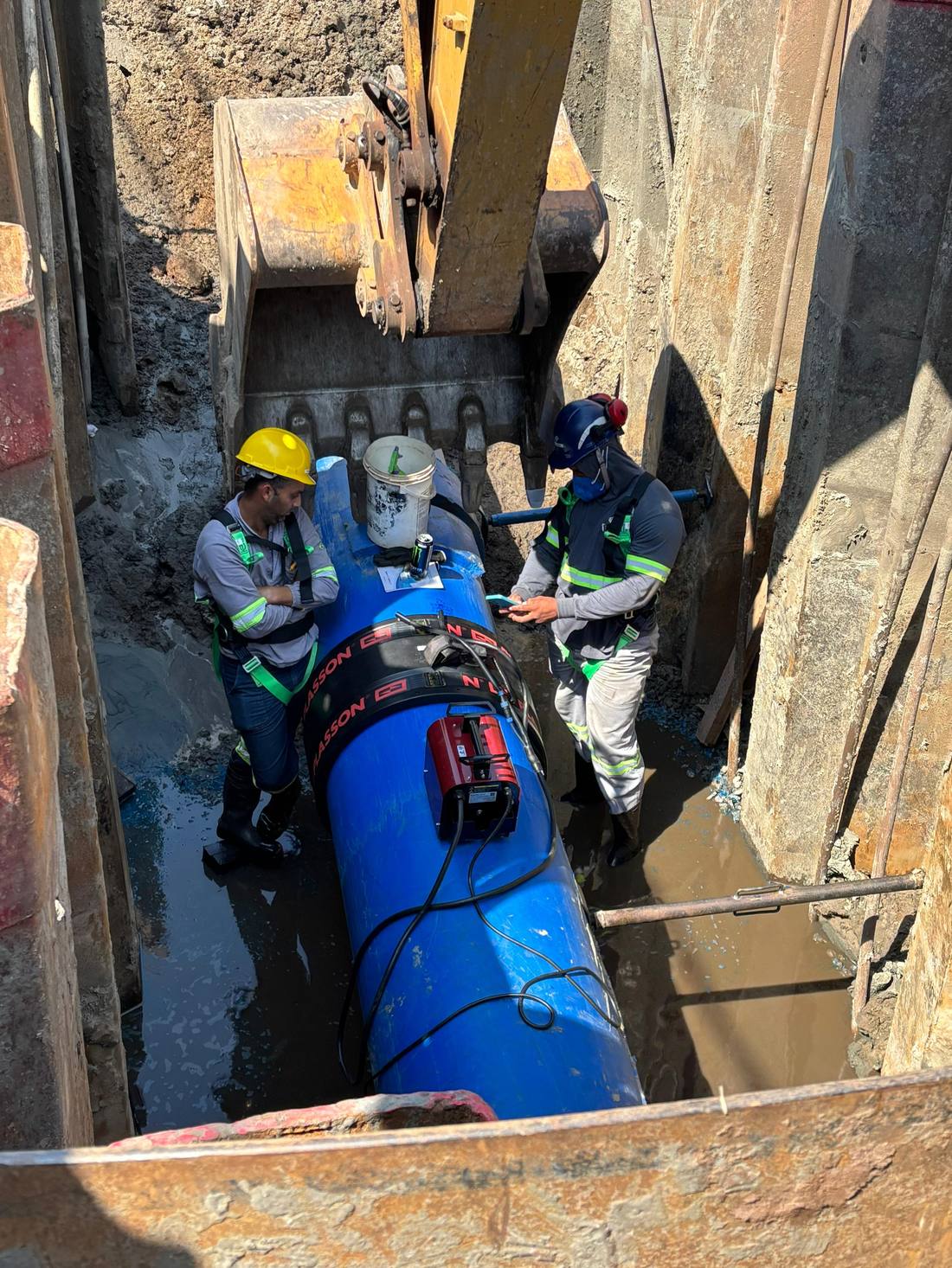 Sertec technicians performing an electrofusion weld on HDPE pipe at a job site